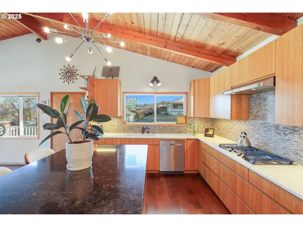 a large white kitchen with a large window