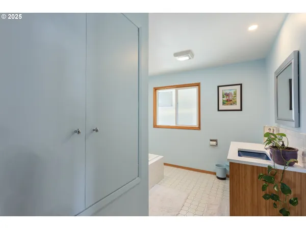 a bathroom with a sink a toilet and mirror