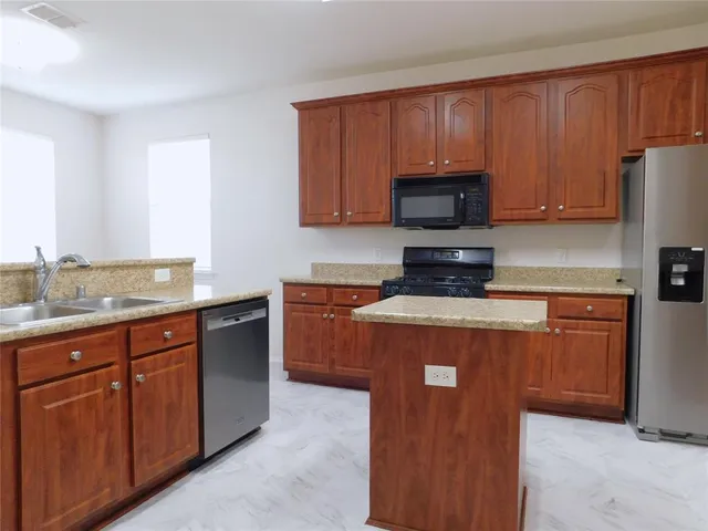 a kitchen with a stove microwave and refrigerator