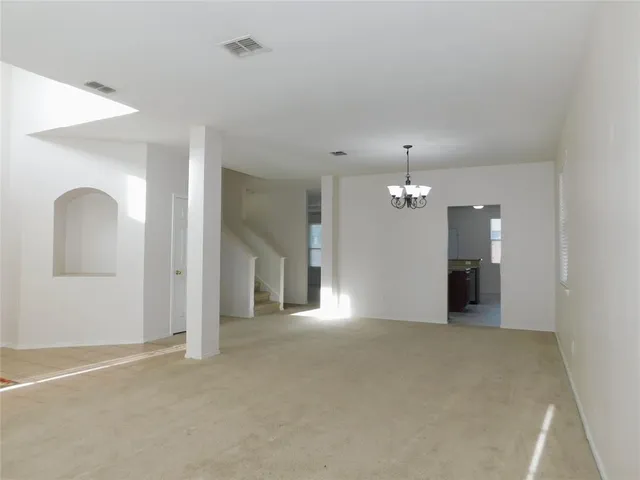 a view of a livingroom with a ceiling fan and window