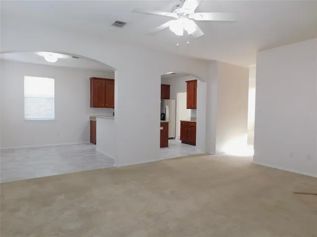 a view of empty room with a fireplace