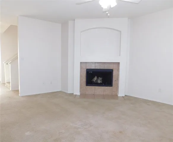 an empty room with windows and a fireplace