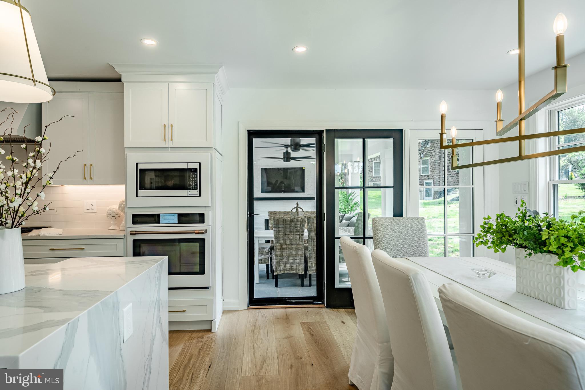 2058 Waterloo Road Berwyn, PA 19312 - Photo 11 of 46 a living room with furniture a fireplace and a kitchen view