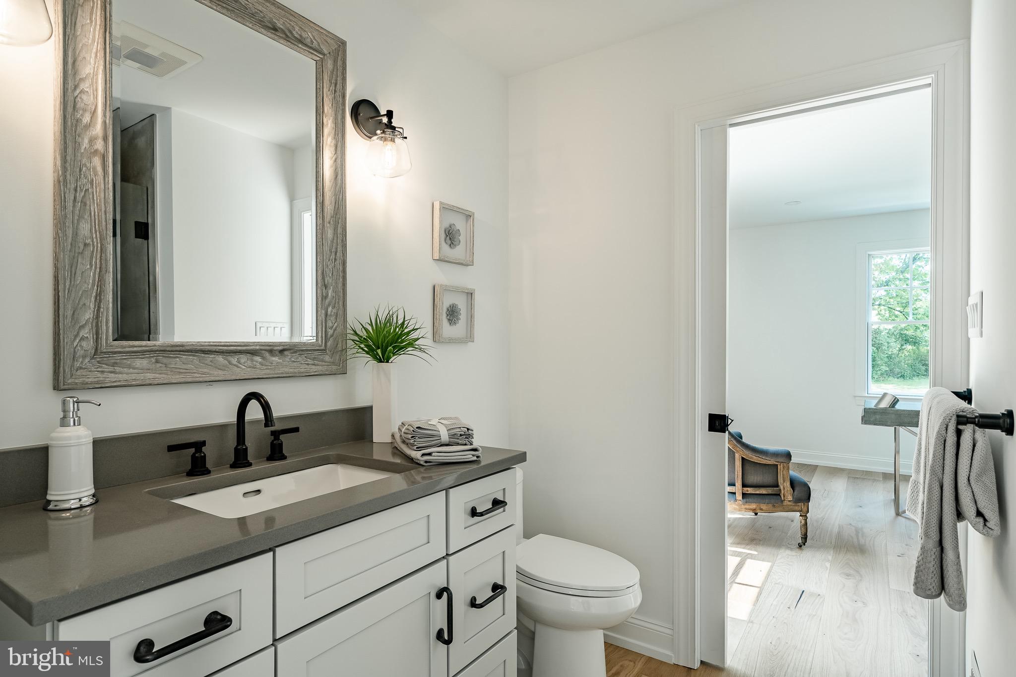 2058 Waterloo Road Berwyn, PA 19312 - Photo 22 of 46 a bathroom with a toilet sink and mirror