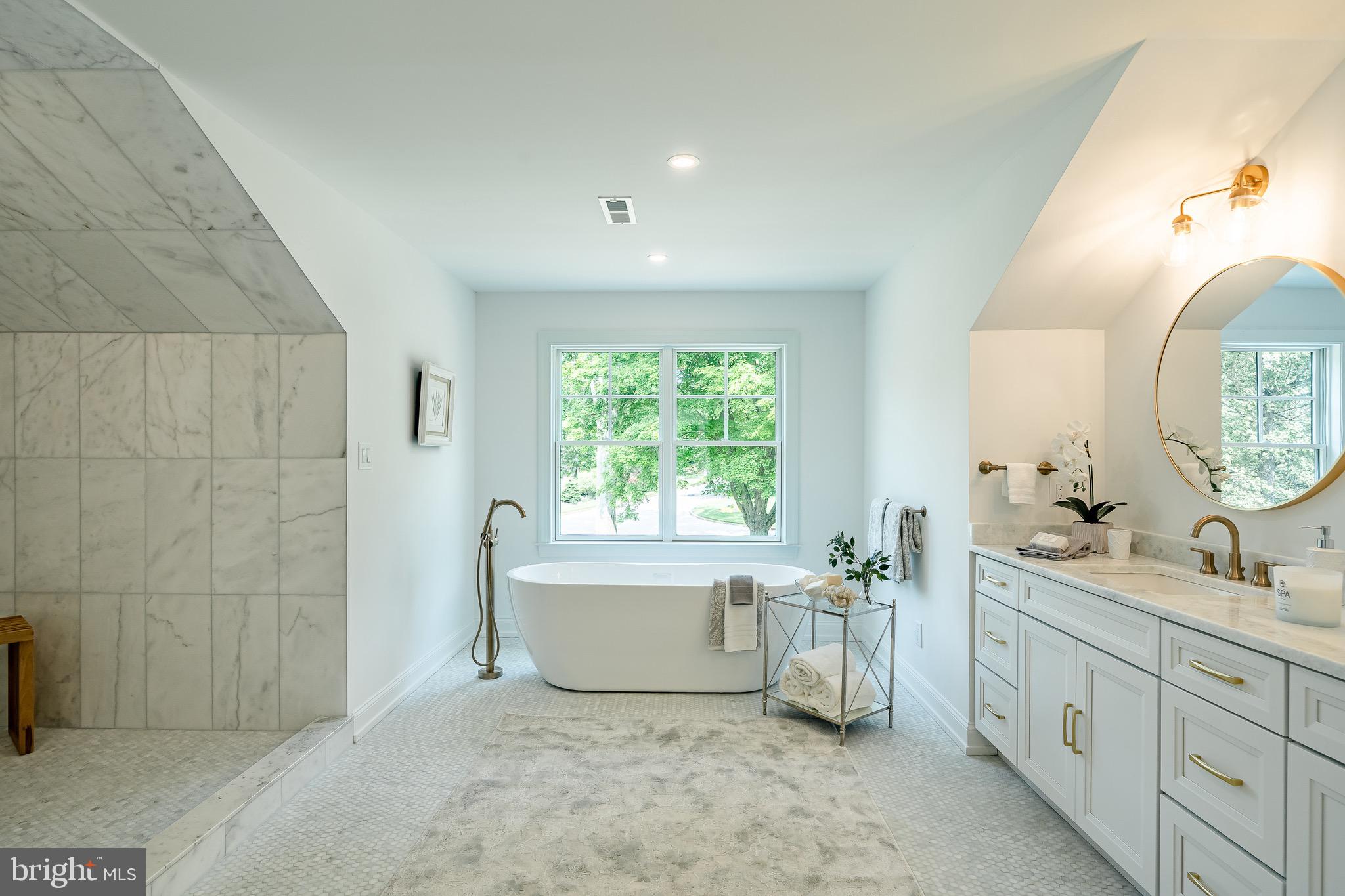 2058 Waterloo Road Berwyn, PA 19312 - Photo 34 of 46 a spacious bathroom with double vanity sink a two mirror a window a bathtub and vanity