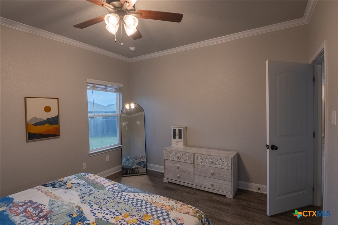 7909 McCulloch Road Temple, TX 76502 - Photo 31 of 46 a bedroom with a bed and a chandelier fan