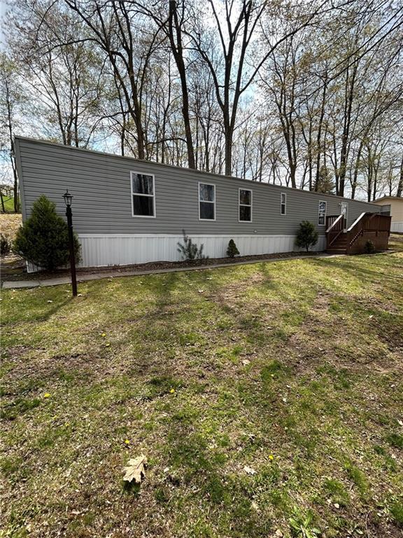 507 Reed Lane Butler, PA 16001 - Photo 1 of 21 a backyard of a house with lots of plants and large tree