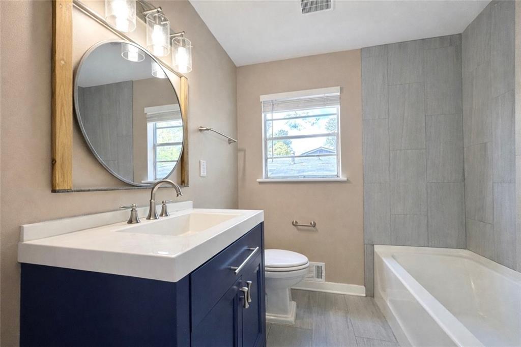 1291 Lorenzo Drive Southwest Atlanta, GA 30310 - Photo 12 of 20 a bathroom with a sink a toilet and a mirror