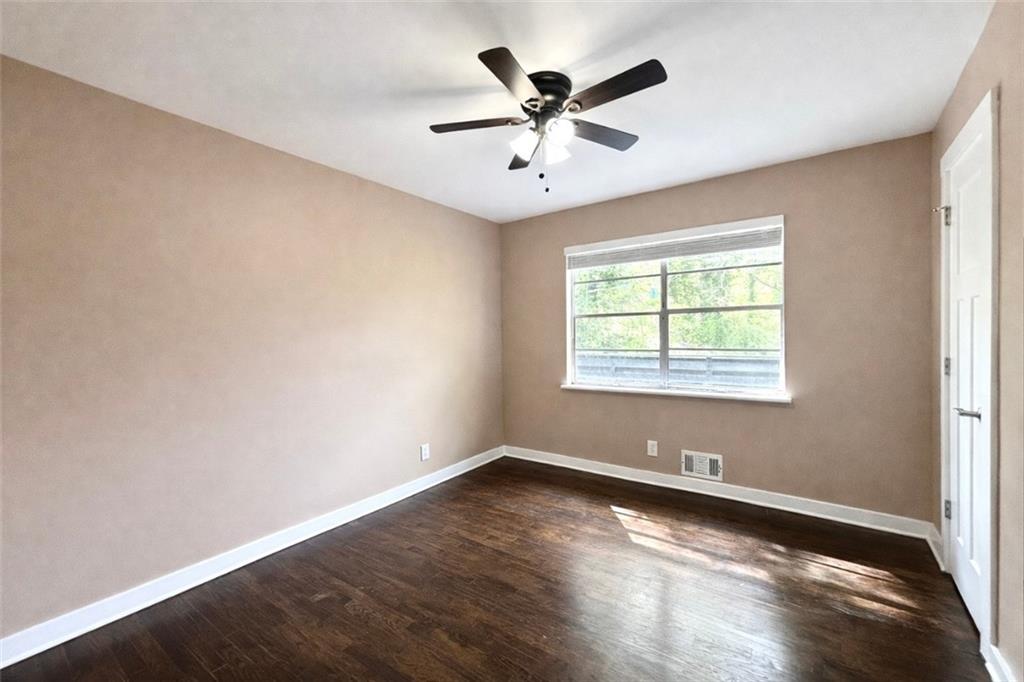 1291 Lorenzo Drive Southwest Atlanta, GA 30310 - Photo 17 of 20 an empty room with wooden floor and windows