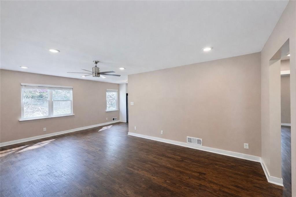 1291 Lorenzo Drive Southwest Atlanta, GA 30310 - Photo 3 of 20 an empty room with wooden floor and windows