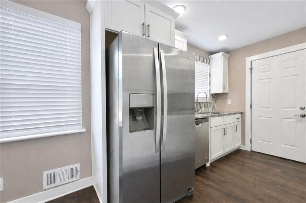 1291 Lorenzo Drive Southwest Atlanta, GA 30310 - Photo 6 of 20 a kitchen with stainless steel appliances a refrigerator sink and cabinets