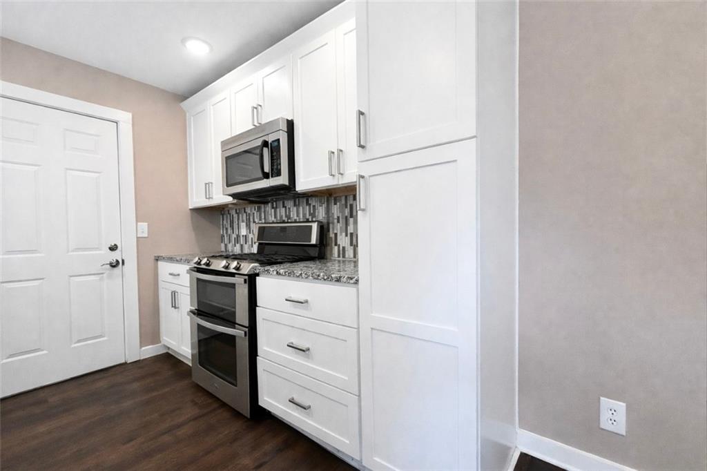1291 Lorenzo Drive Southwest Atlanta, GA 30310 - Photo 7 of 20 a kitchen with stainless steel appliances a stove microwave and sink