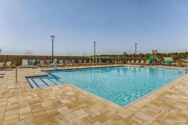 a view of a lake with boats and palm trees