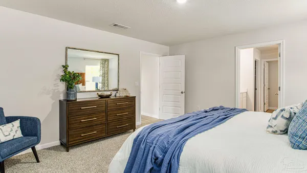 a bedroom with a bed and a dresser