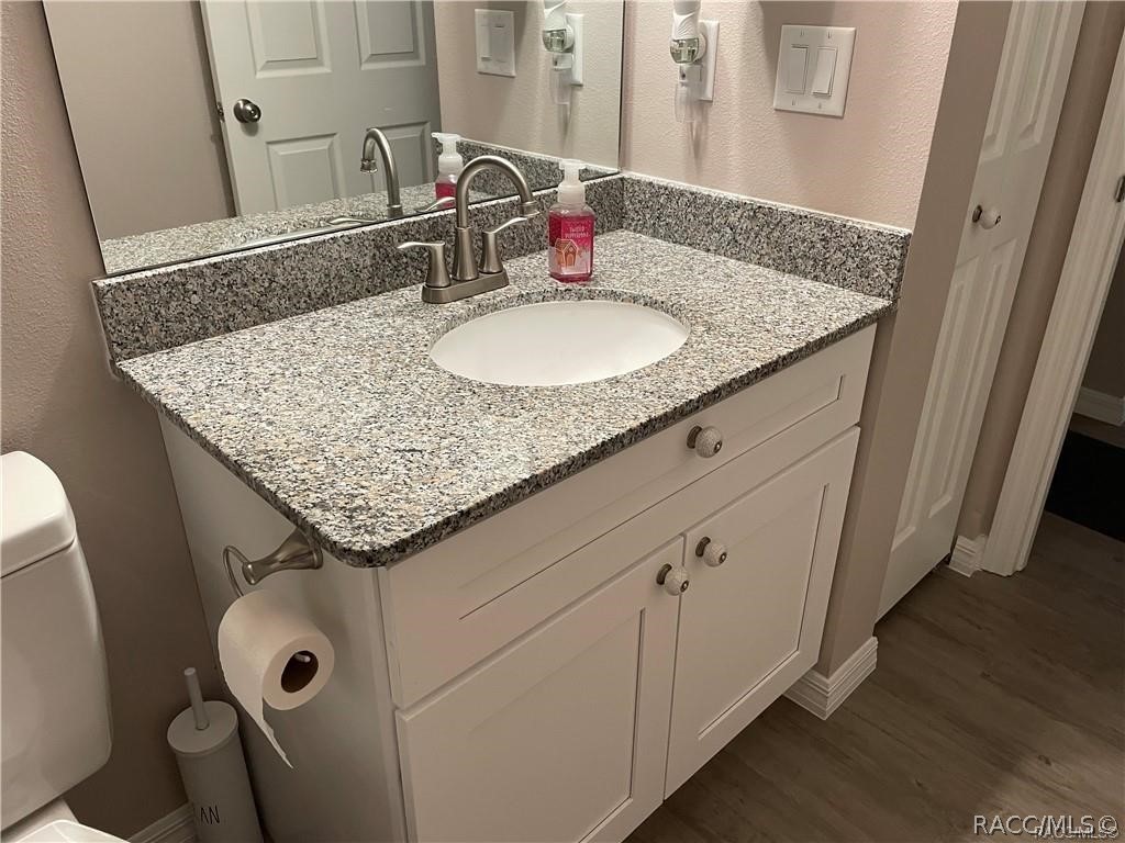 13591 Southwest 112th Street Dunnellon, FL 34432 - Photo 17 of 24 a bathroom with a granite countertop sink a mirror and vanity