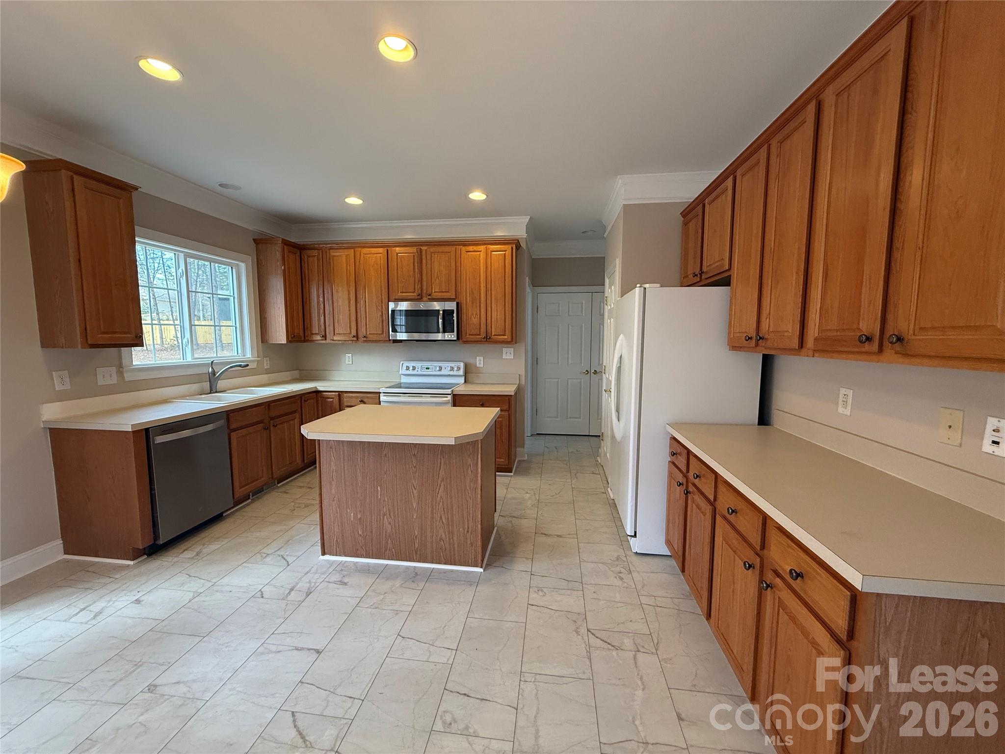 3993 Lake Shore Road South Denver, NC 28037 - Photo 13 of 39 a large kitchen with stainless steel appliances kitchen island granite countertop a sink and a refrigerator
