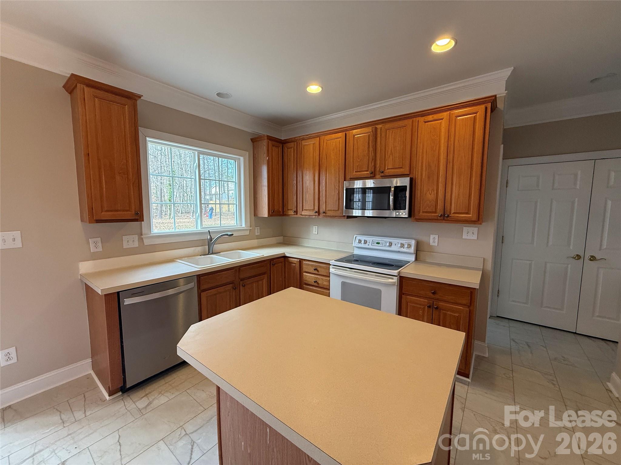 3993 Lake Shore Road South Denver, NC 28037 - Photo 14 of 39 a kitchen with stainless steel appliances granite countertop a sink a stove a refrigerator a center island and cabinets