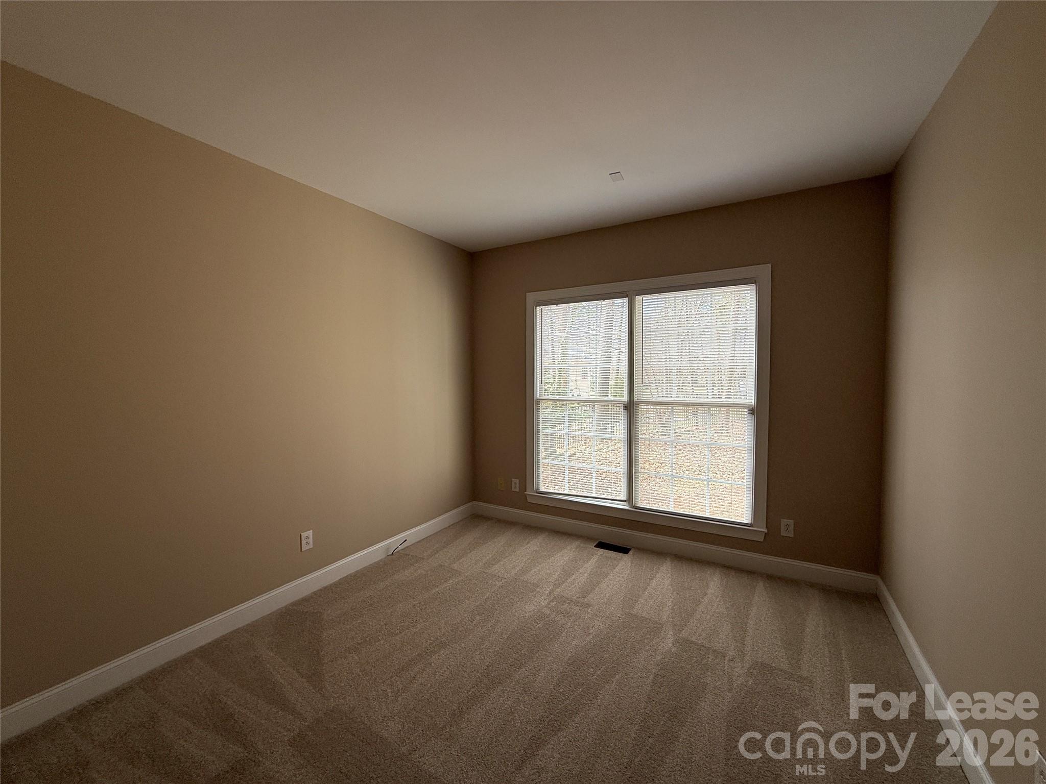 3993 Lake Shore Road South Denver, NC 28037 - Photo 19 of 39 an empty room with wooden floor and windows