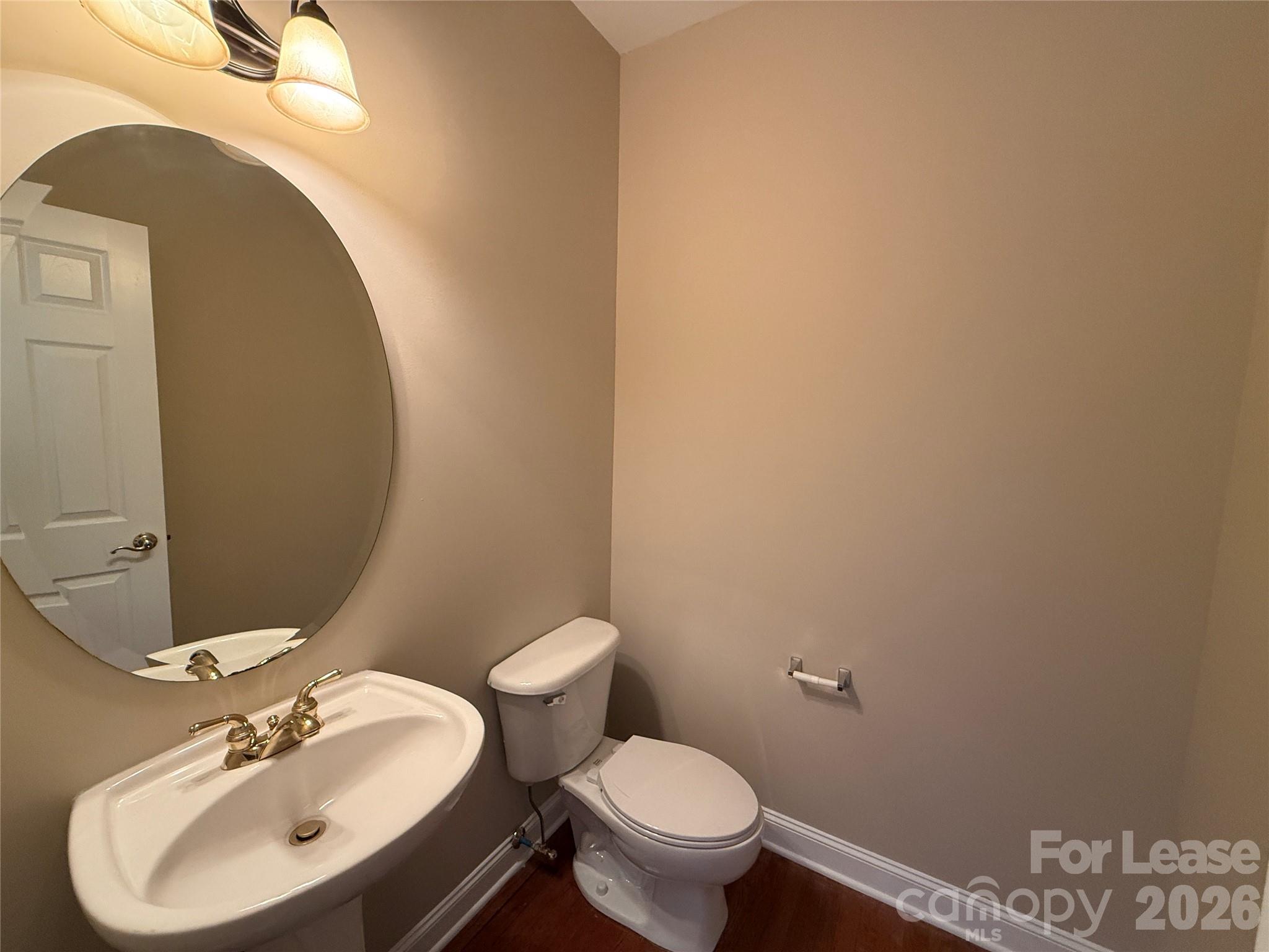 3993 Lake Shore Road South Denver, NC 28037 - Photo 20 of 39 a bathroom with a sink mirror and toilet