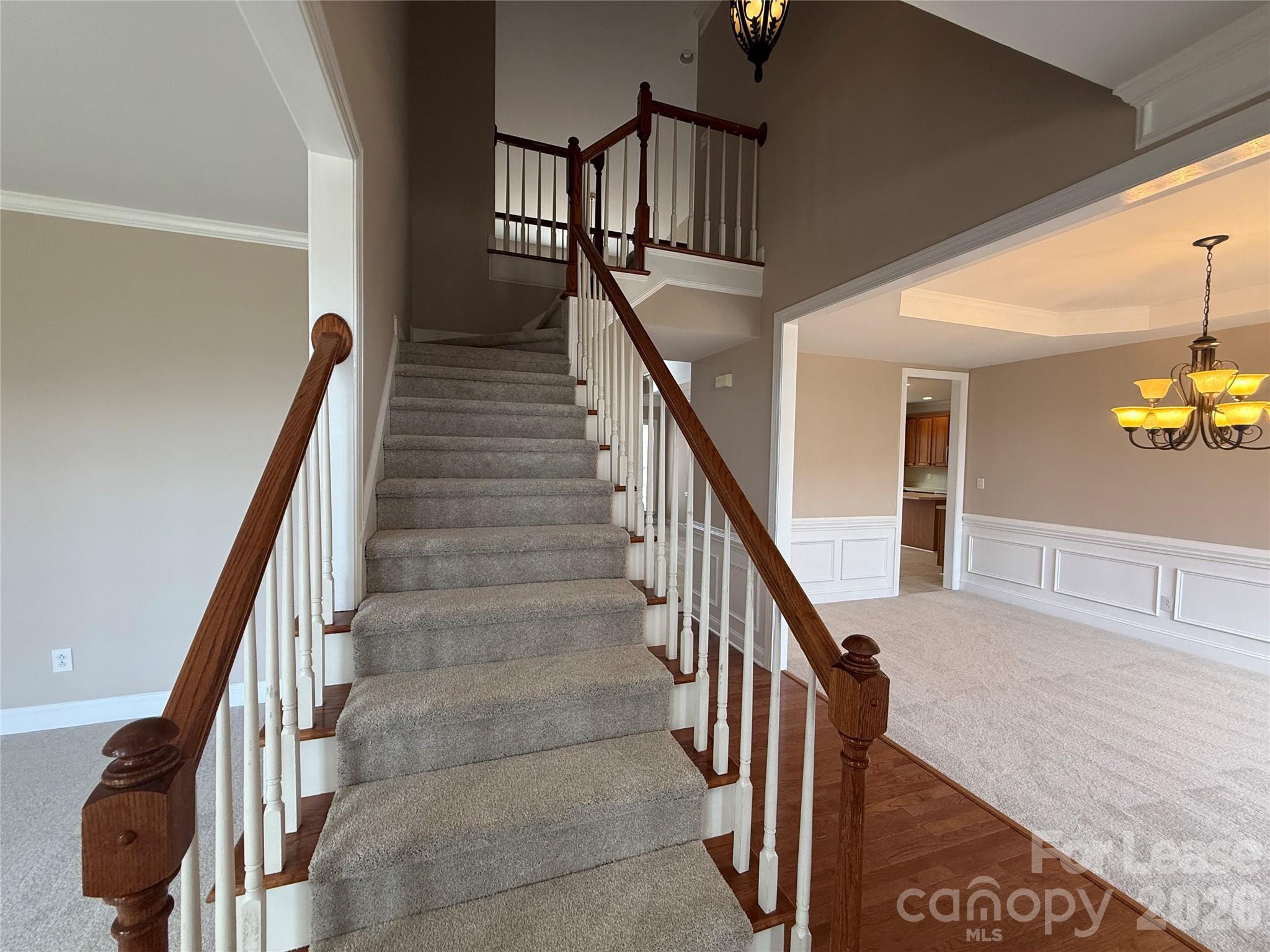 3993 Lake Shore Road South Denver, NC 28037 - Photo 21 of 39 a view of staircase with lots of frames on wall and wooden floor