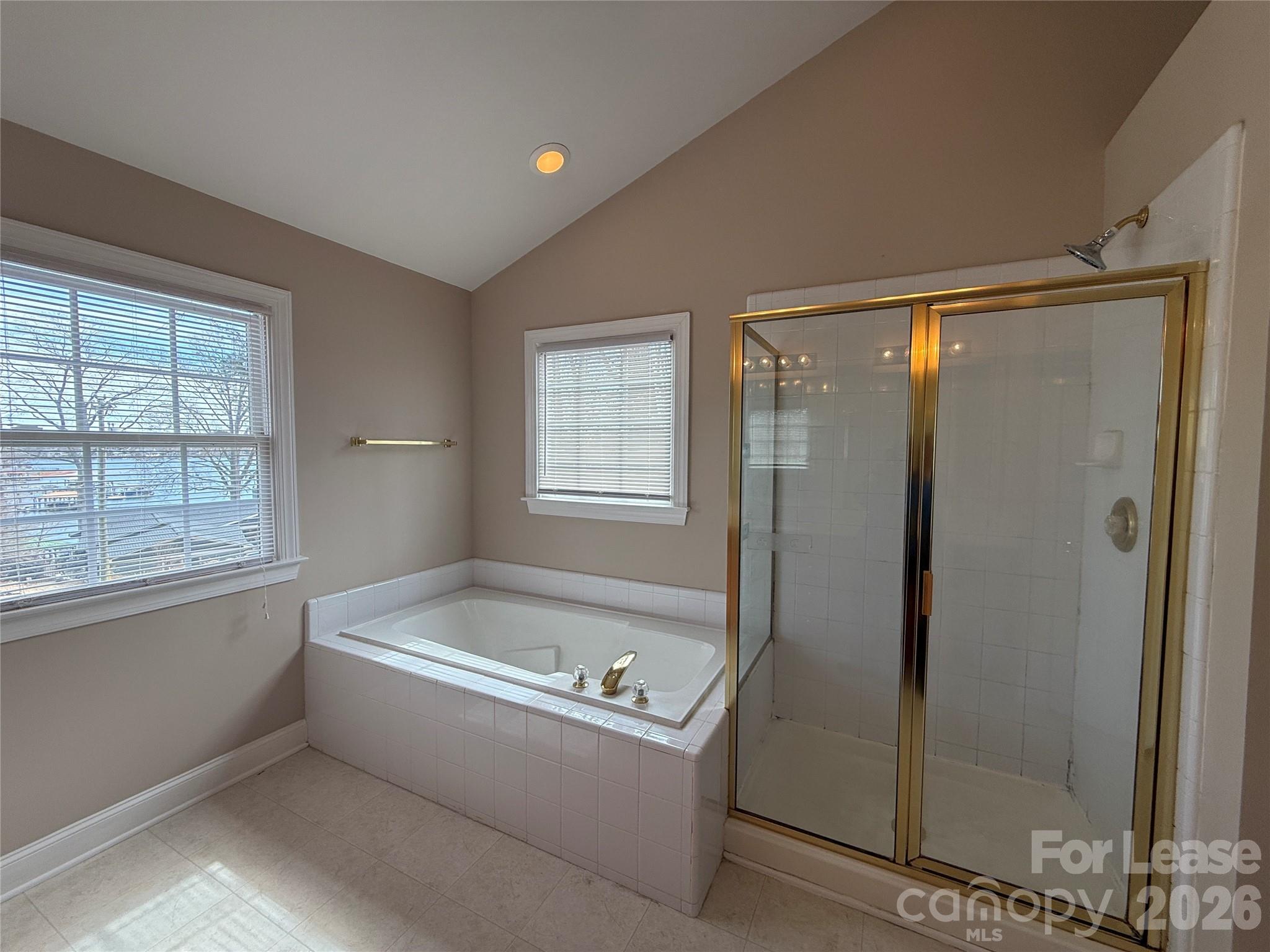 3993 Lake Shore Road South Denver, NC 28037 - Photo 27 of 39 a bathroom with a bathtub and a shower
