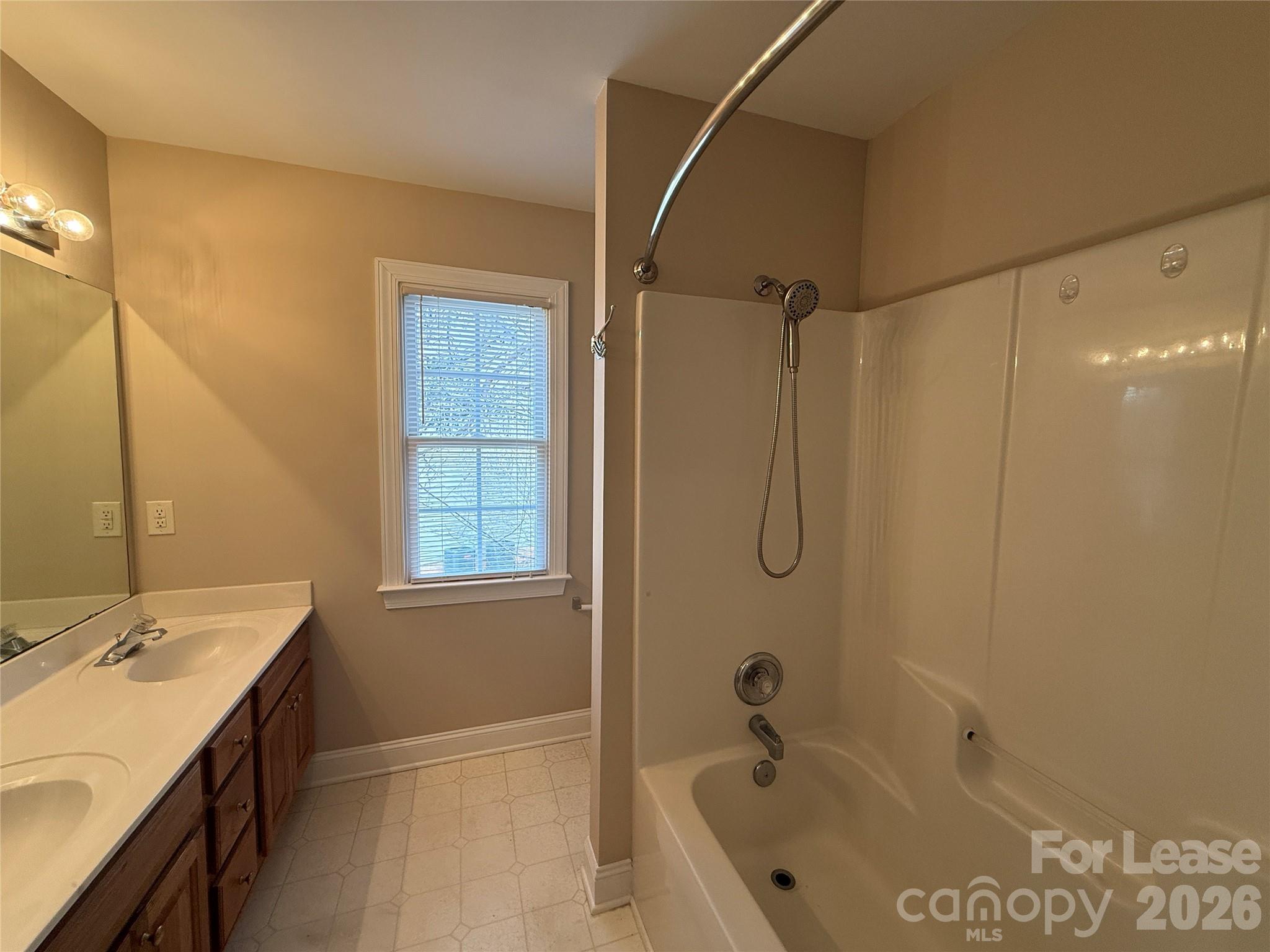 3993 Lake Shore Road South Denver, NC 28037 - Photo 33 of 39 a bathroom with a tub a sink a mirror and a shower