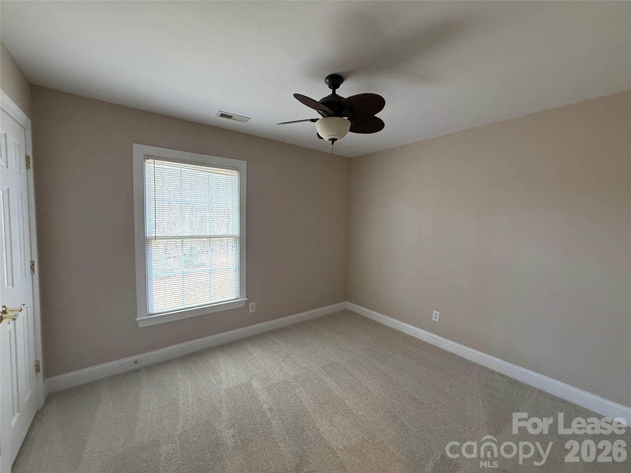 3993 Lake Shore Road South Denver, NC 28037 - Photo 35 of 39 an empty room with a window and a ceiling fan