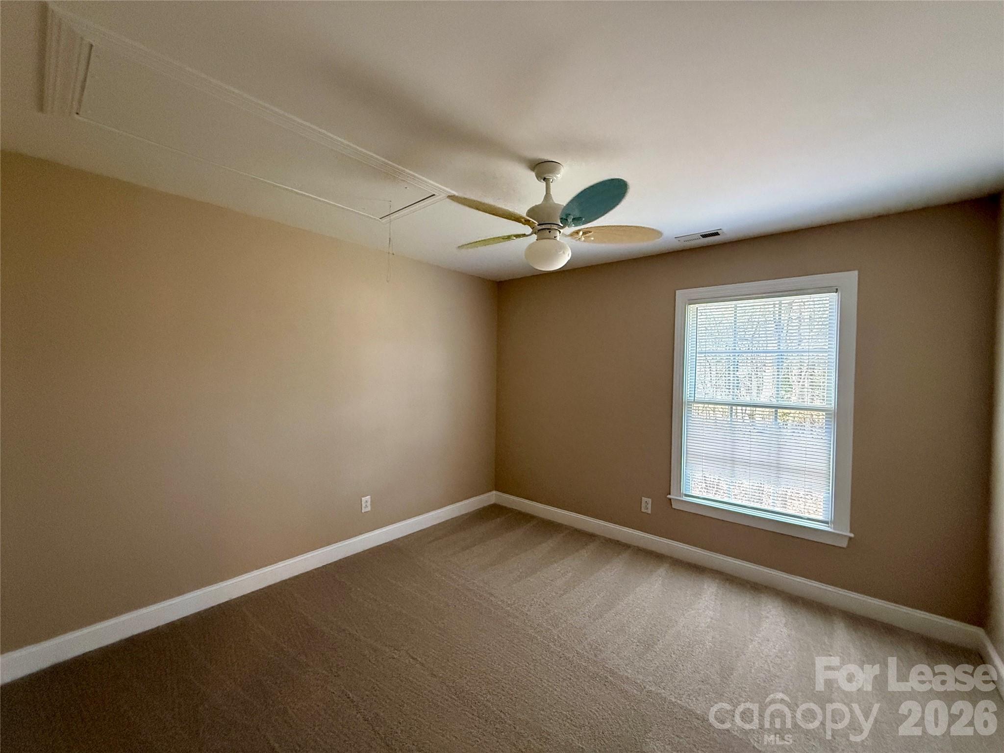 3993 Lake Shore Road South Denver, NC 28037 - Photo 38 of 39 an empty room with a window and a fan