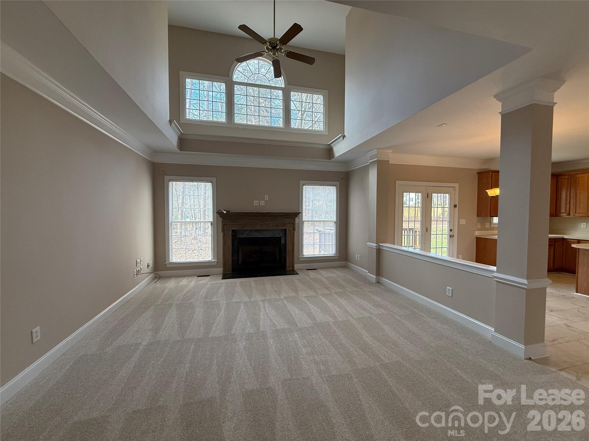 3993 Lake Shore Road South Denver, NC 28037 - Photo 9 of 39 a view of an empty room with a fireplace and a window