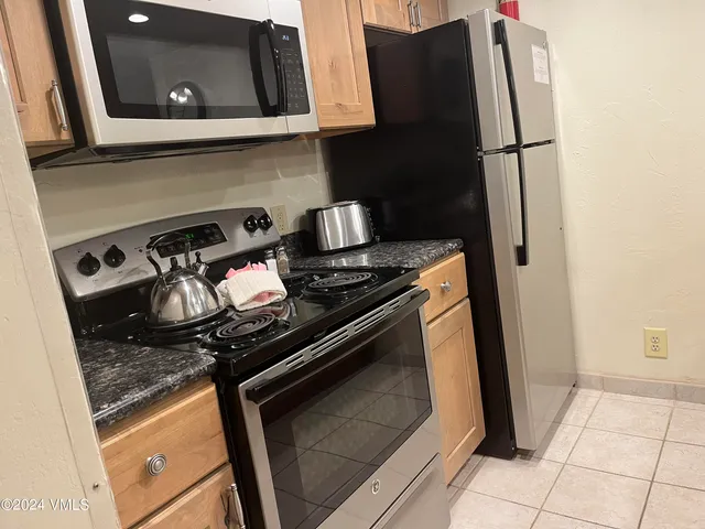 a close view of a stove and refrigerator