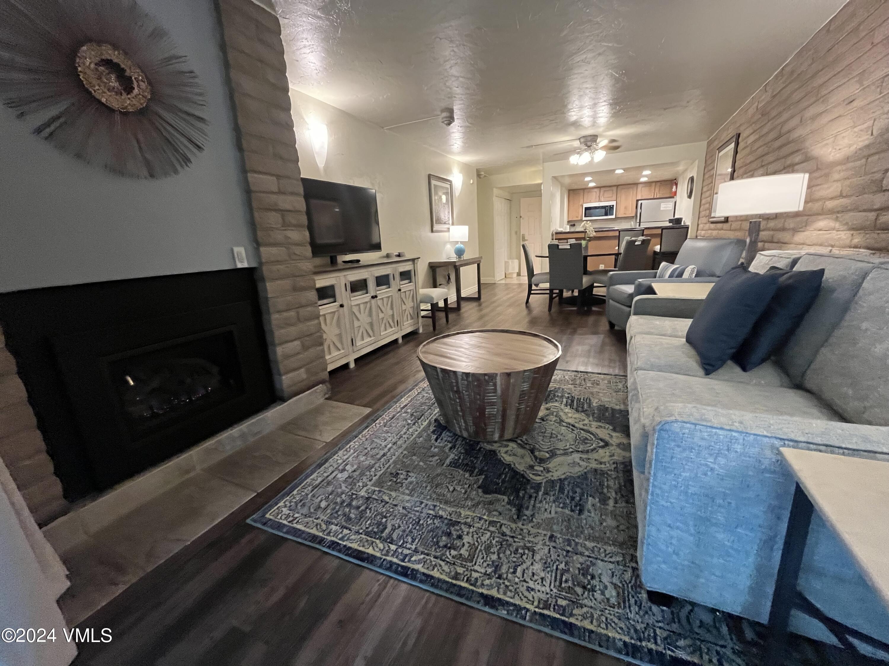 1020 Vail View Drive, Unit 311247 Vail, CO 81657 - Photo 3 of 23 a living room with furniture and a flat screen tv