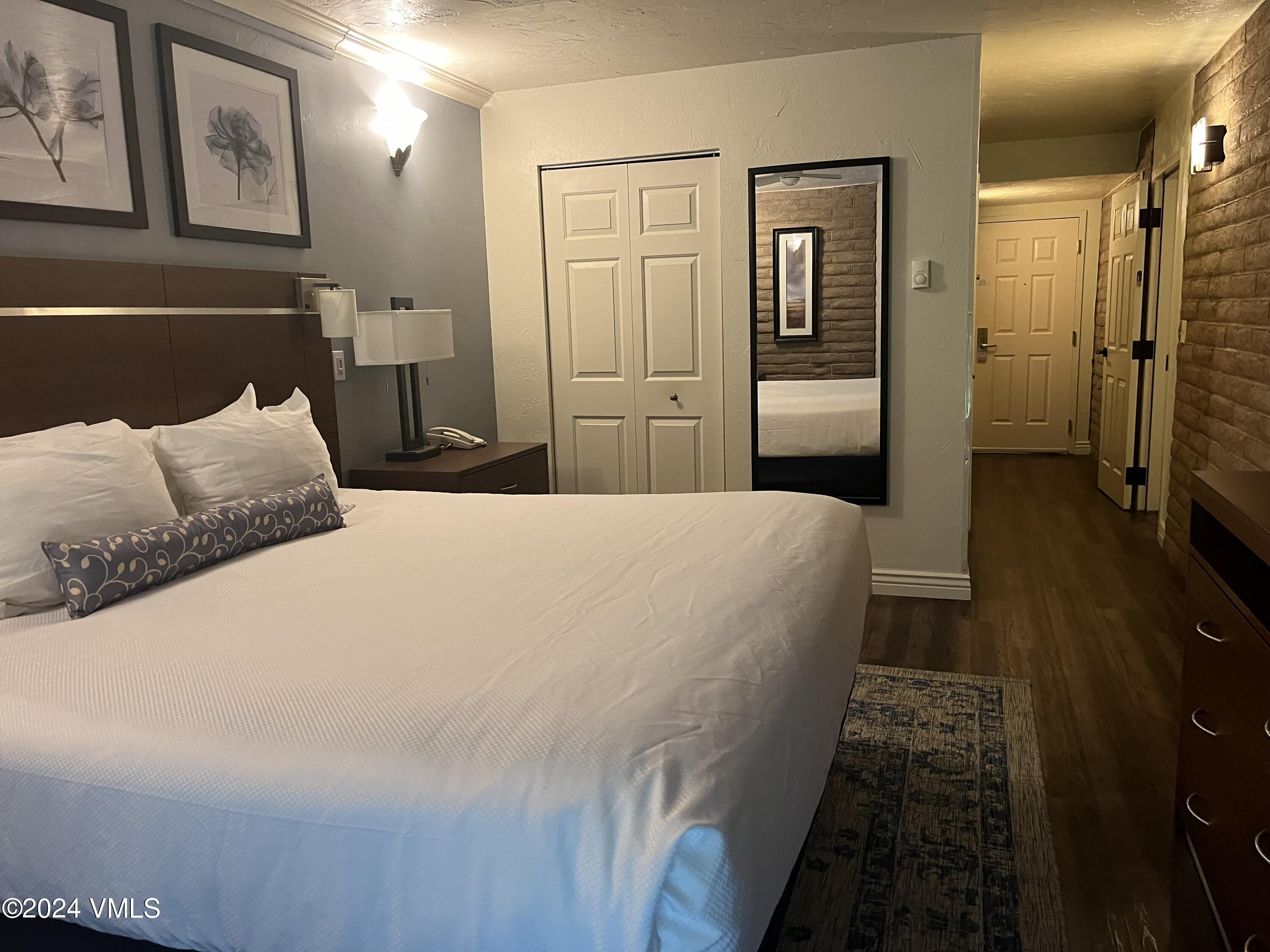 1020 Vail View Drive, Unit 311247 Vail, CO 81657 - Photo 4 of 23 a bedroom with a bed and wooden floor