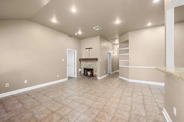 a view of an empty room with a fireplace