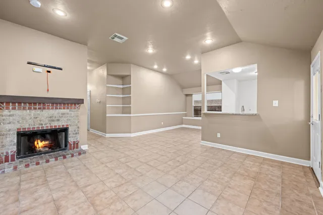 a view of an empty room with a fireplace