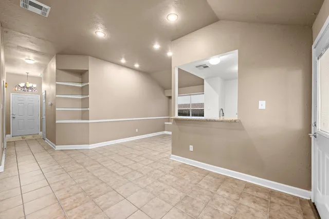 an empty room with cabinet and mirrors