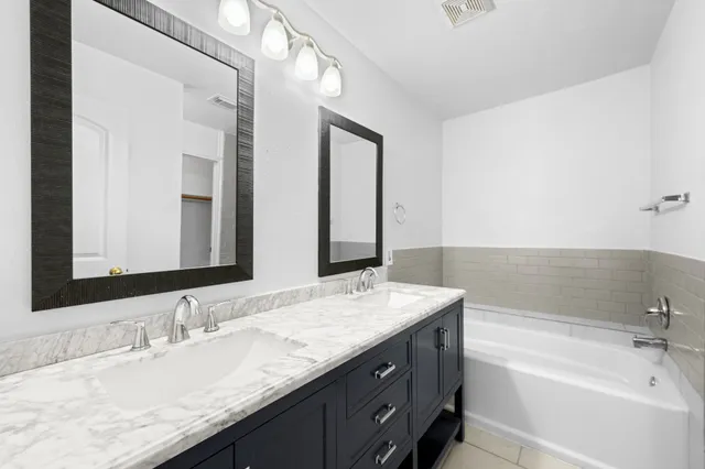 a bathroom with a granite countertop sink mirror and double