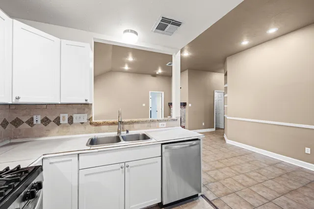 a kitchen with a sink and cabinets