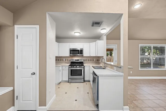a kitchen with a stove a sink and a refrigerator