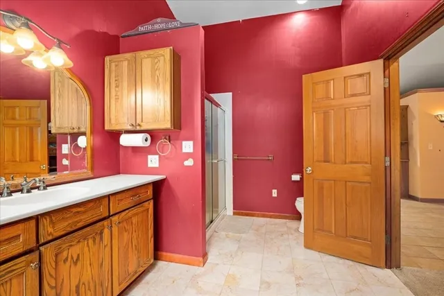 a bathroom with a sink a mirror and a shower