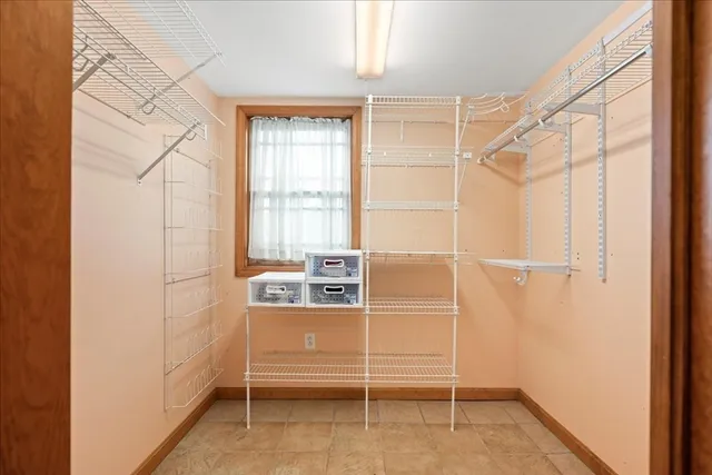 a room with walk in closet and window