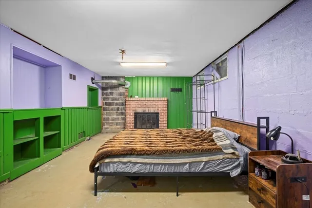 a bed sitting in a spacious bedroom next to a window