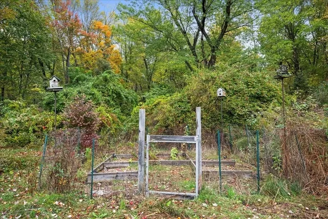 a backyard of a house with table and chairs