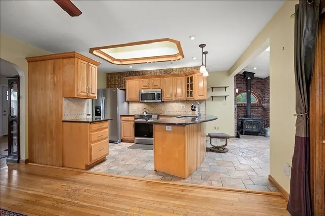 a kitchen with stainless steel appliances granite countertop a stove top oven a sink and cabinets