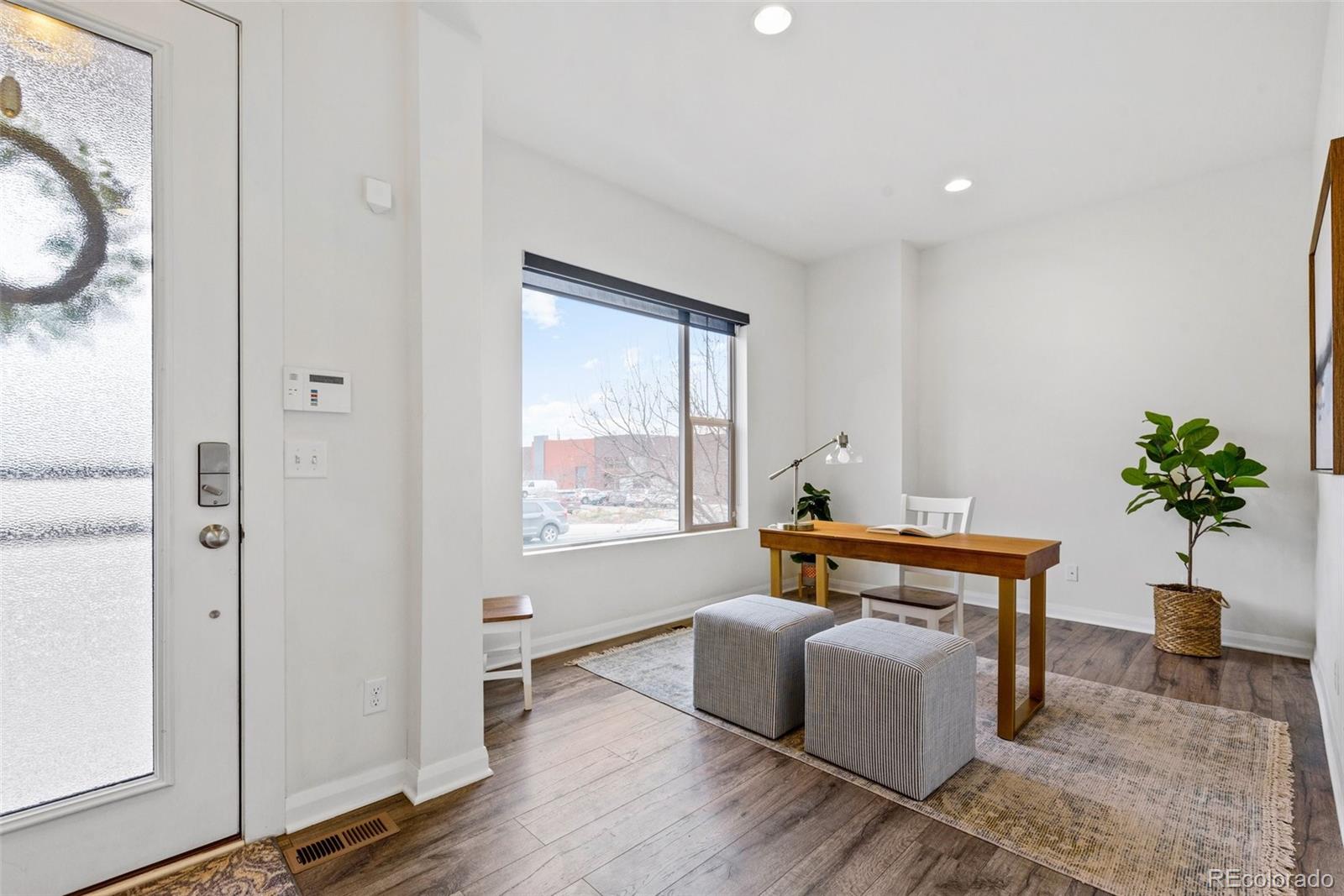 6731 Raritan Drive Denver, CO 80221 - Photo 12 of 40 a living room with furniture a potted plant and a window
