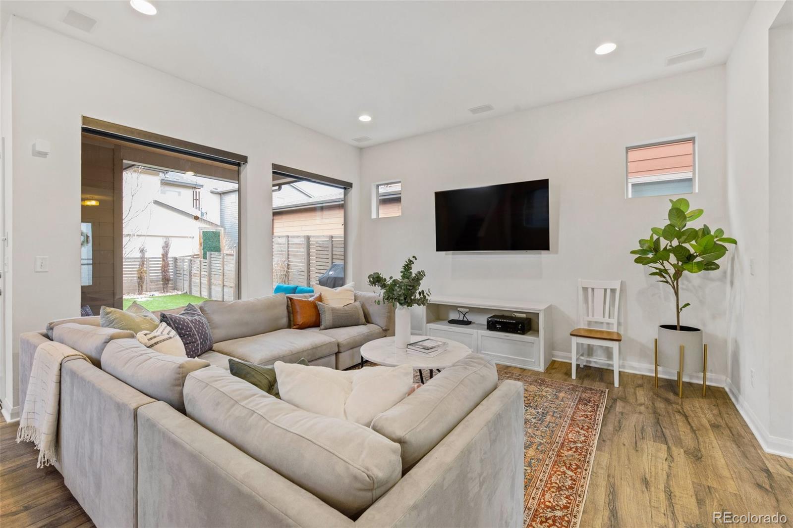 6731 Raritan Drive Denver, CO 80221 - Photo 16 of 40 a living room with furniture a large window and a flat screen tv
