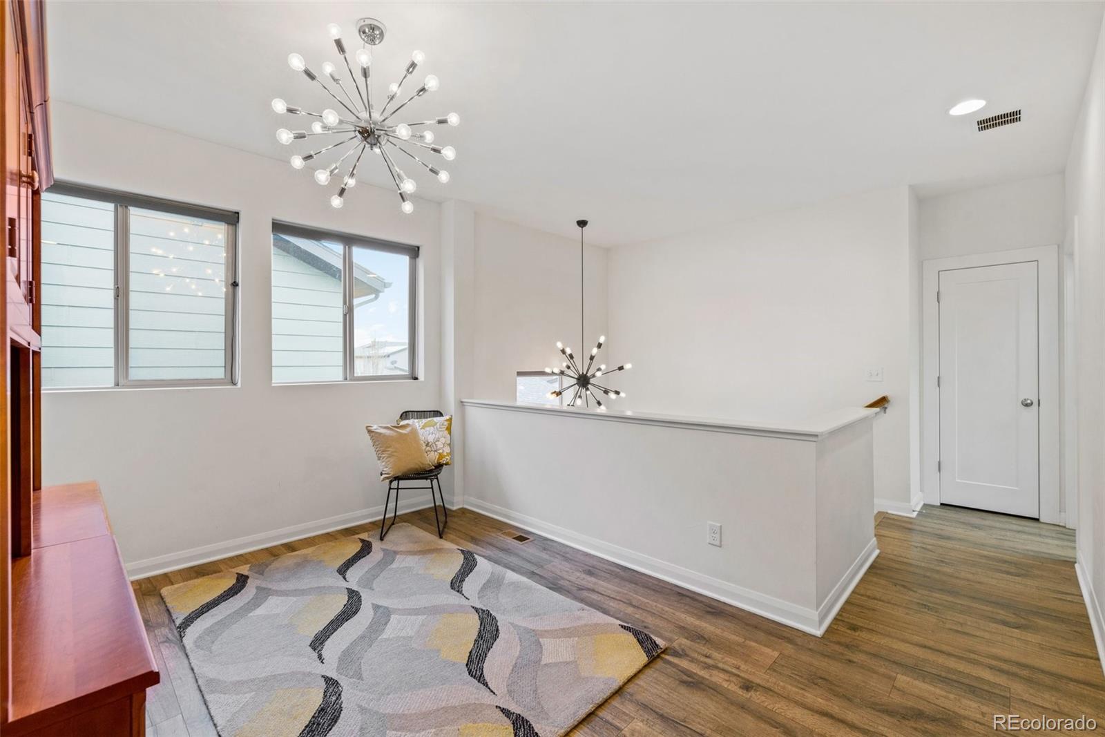 6731 Raritan Drive Denver, CO 80221 - Photo 19 of 40 a room with wooden floor and window