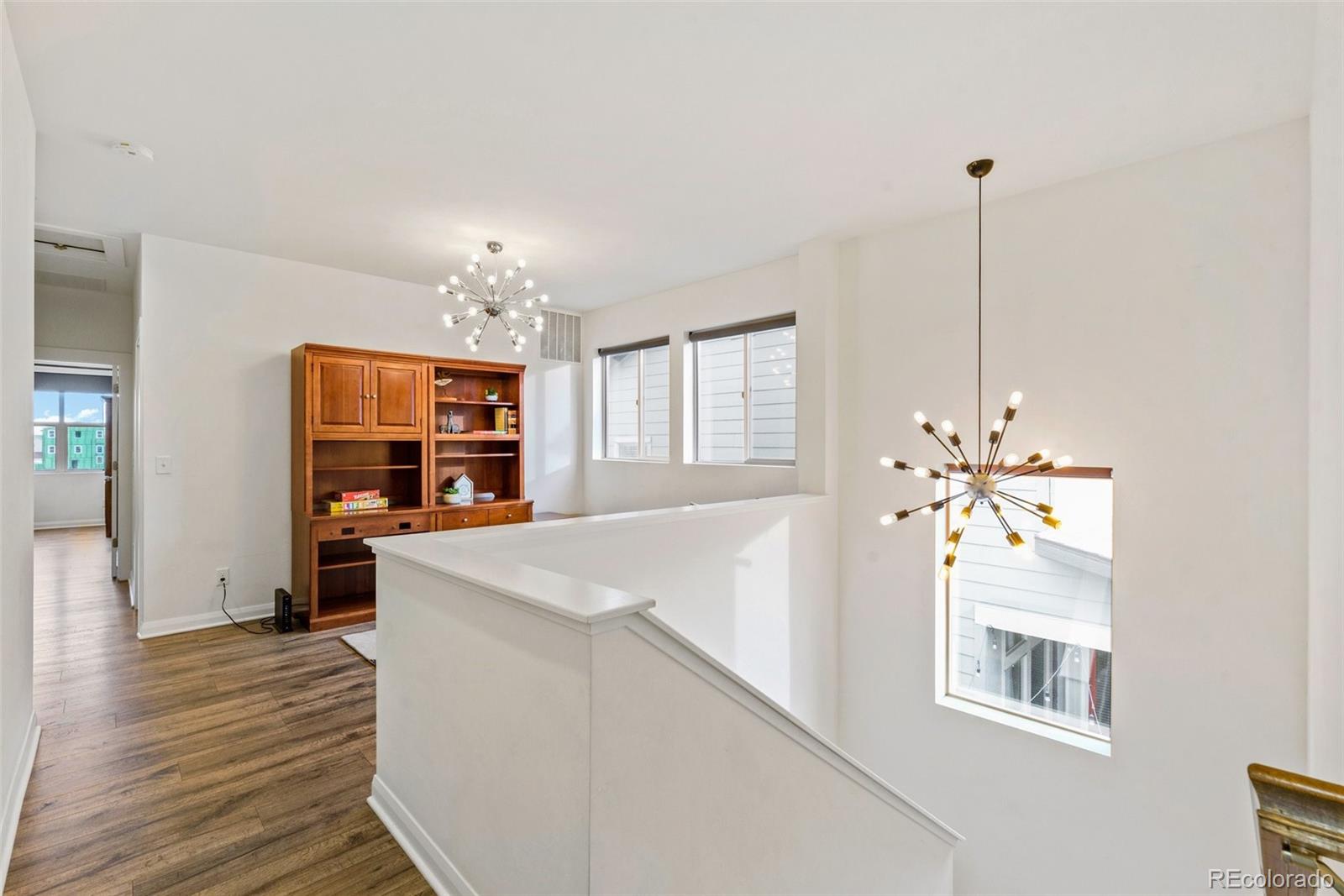 6731 Raritan Drive Denver, CO 80221 - Photo 20 of 40 a very nice looking room with a large window a chandelier