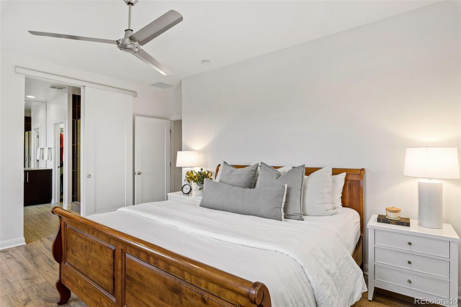 6731 Raritan Drive Denver, CO 80221 - Photo 21 of 40 a bedroom with a bed and a night stand