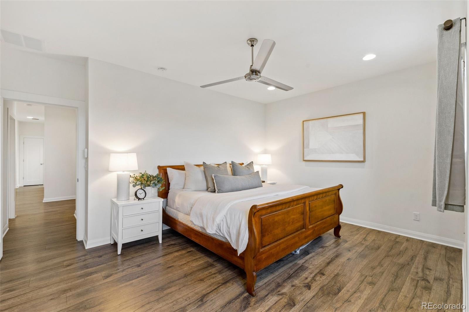 6731 Raritan Drive Denver, CO 80221 - Photo 22 of 40 a bedroom with a bed and a ceiling fan