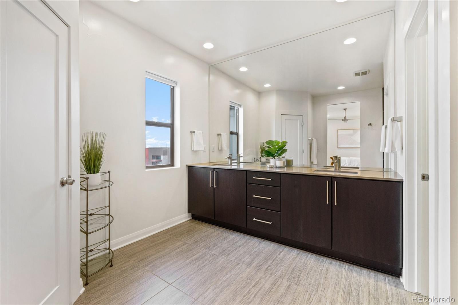 6731 Raritan Drive Denver, CO 80221 - Photo 24 of 40 a room with a dresser and a wooden floor